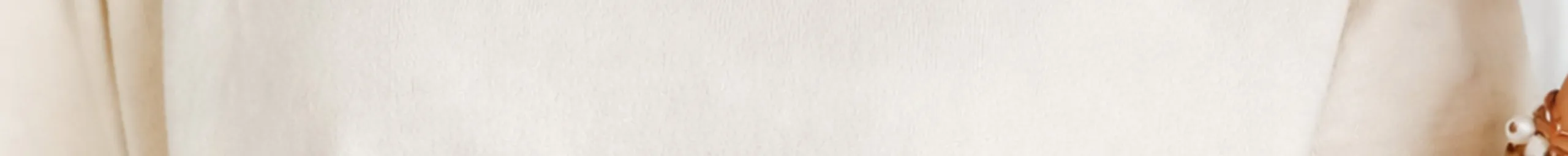 A garment-dyed Comfort Colors tee in Ivory, showing the soft uneven surface of pigment dye.