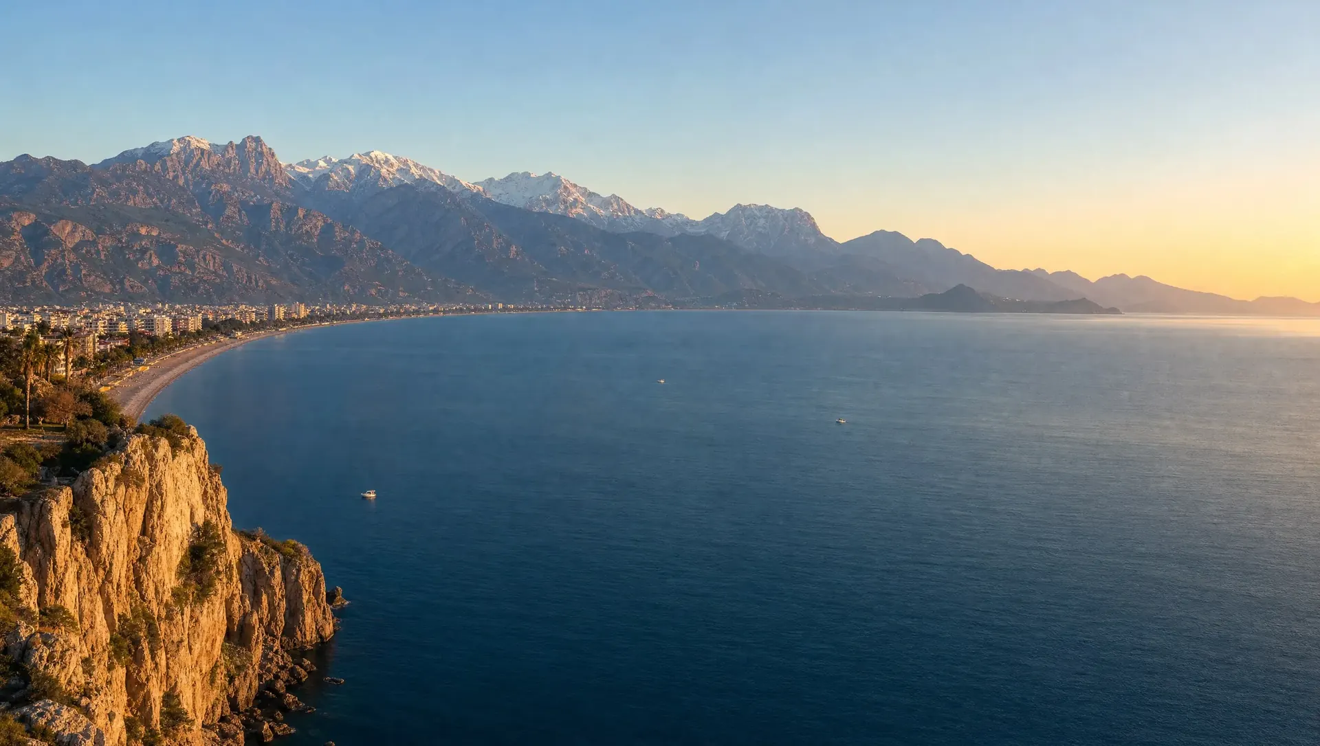 Konyaaltı bay and the snow-capped Beydağları range of the Taurus mountains from the travertine cliffs of Antalya at golden hour